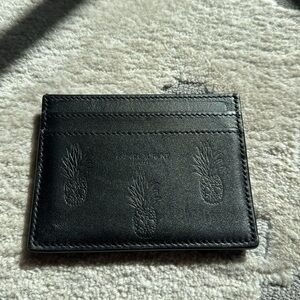 SAINT LAURENT
Pineapple Embossed Card Holder in Black, Skulls and pineapple.
